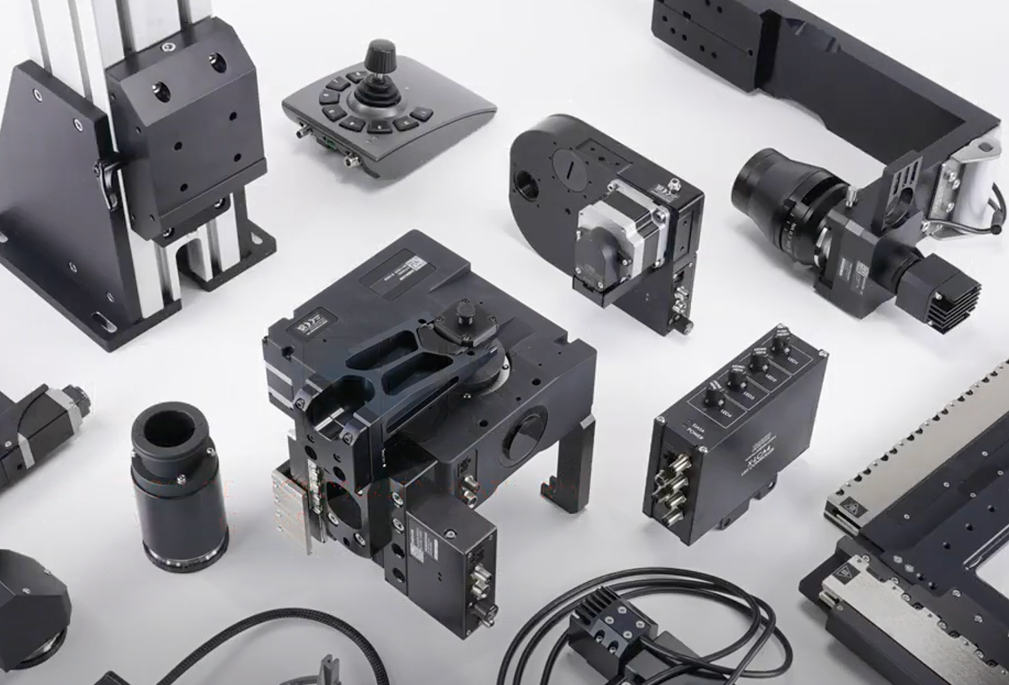 Collection of Ensorcell Celluar Focus precision components for a custom microscope imaging system, including motorized stages, optical mounts, controllers, and lenses used in advanced microscopy applications