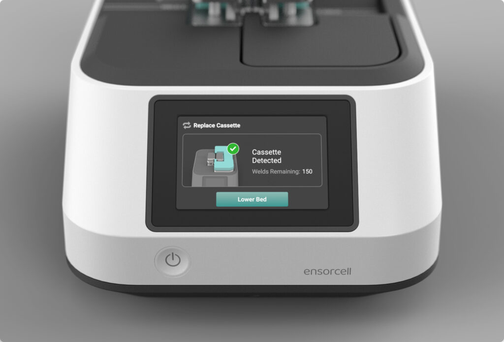 An Ensorcell VersaWeld sterile tube welder with touchscreen display showing cassette detection status for bioprocessing and aseptic tube welding applications sits atop a dark gray background.