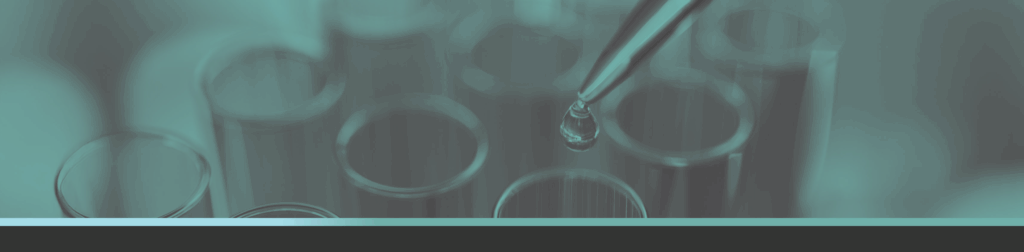 Test tubes with dropper holding liquid and a drop about to fall; all in a teal overtone