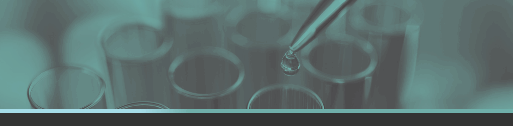 Test tubes with dropper holding liquid and a drop about to fall; all in a teal overtone