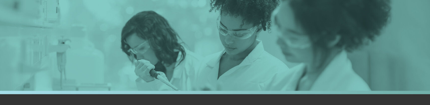 researchers in modern day lab using small-footprint bioprocessing equipment