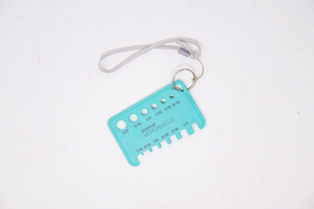Flat, top‑down view of the tube gauge with an integrated slot for attaching a keyring and lanyard.